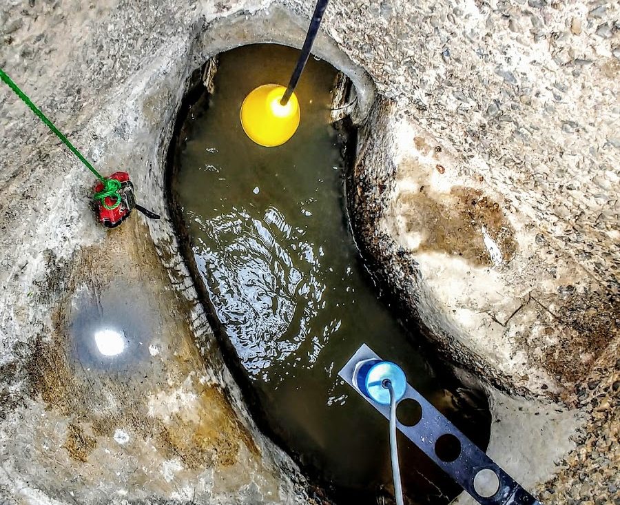 A sewer chamber with a level float and an area velocity sensor installed in the flow